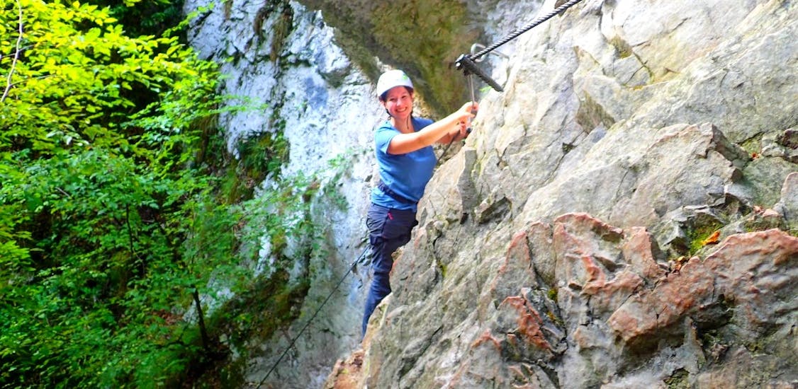 Woman smiling during a via ferrata in Rio Sallagoni for beginners with SKYclimber Tremosine