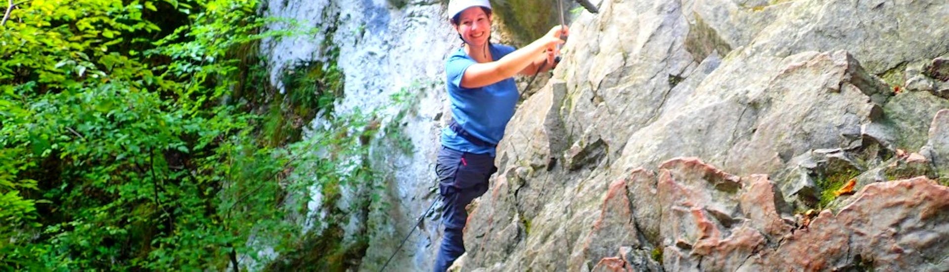 Woman smiling during a via ferrata in Rio Sallagoni for beginners with SKYclimber Tremosine