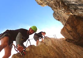 A girl is facing a via ferrata with Skyclimber's guide during the Via Ferrata Monte Albano Ultimate Adrenaline.