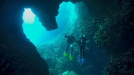 Two divers in an underwater cave during their PADI Advanced Open Water Diver Course in Dubrovnik with Diving Center Blue Planet Dubrovnik.