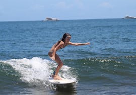 A kid is having her Private Surfing Lessons for All Levels from 8 years with It's On Surf School.
