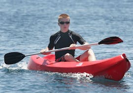 A young man is paddling during the Canoe Rental in Santorini with Wavesports Santorini.