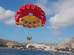 During the Parasailing close to Agios Georgios, a group of friends is enjoying the 360 degree views from a bird's-eye view whilst being towed and watched by professional staff from Crazy Sports.