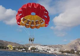 parasailing-agios-georgios-crazy-sports-cover During the Parasailing close to Agios Georgios, a group of friends is enjoying the 360 degree views from a bird's-eye view whilst being towed and watched by professional staff from Crazy Sports.