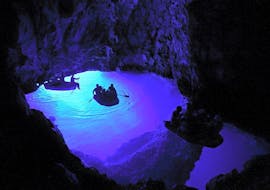 Several boats in a blue cave during a Boat Trip to Blue and Green Cave from Hvar with HvarCruise.
