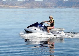 A woman is taking a jet ski circuit with Take Off Ibiza around the beautiful coastline.