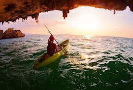 A guy kayaking during the sunset with our Kayak Rental in Ibiza.