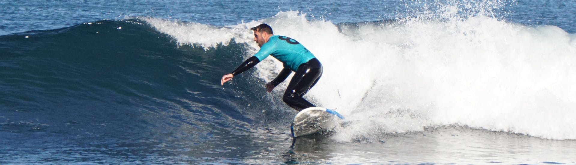 A surfer is controlling his wave during a Private Surfing Lessons (from 5 y.) in Ericeira with Surf Riders Ericeira.