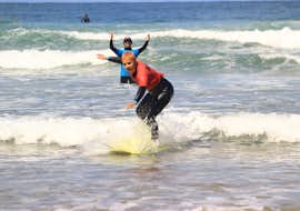 Surfing Lessons for Beginners (from 7 y.) up to 6 people from Algarve Adventure A young surfer is riding their first wave during their surfing lessons for beginners with Algarve Adventure.