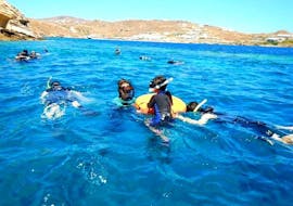 A family enjoying their Snorkeling Adventure Tour in Mykonos together with a local guide from the Mykonos Diving Center.