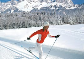A woman enjoying the Cross Country Skiing Lessons for Beginners with the Snow Sports School Eichenhof St. Johann.