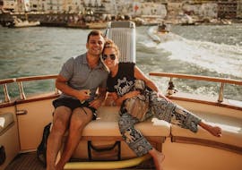 Ein Paar lächelt für das Foto auf dem Boot von Capitano Ago während der privaten Bootsfahrt von Neapel nach Capri.