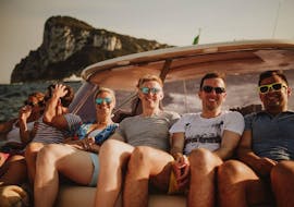 A group of friends laying on the boat and enjoying the sun during the Private Boat Trip from Amalfi to Capri with Capitano Ago.