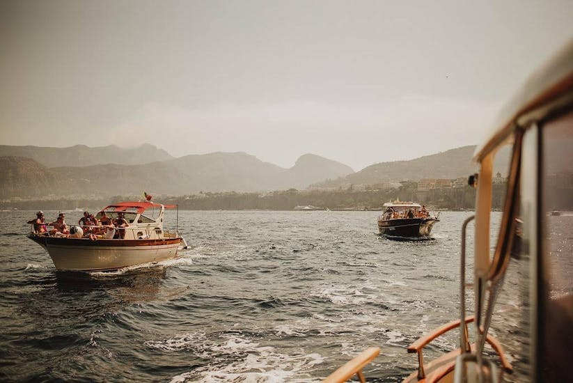 Twee boten varen langs de kust van Amalfi tijdens de privé boottocht van Napels naar de kust van Amalfi met Capitano Ago.