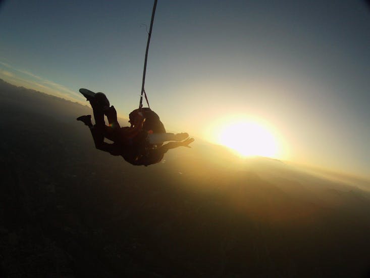 A tandem master from Skydive Center has jumped with a passenger off the plane at an altitude of 4000m in Gap-Tallard under the sunset.