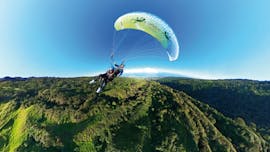 A person is happy to do a Tandem Paragliding Flight "Discovery" over the Bay of St Leu with Addict Parapente.