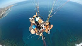 A man is happy to do a Tandem Paragliding Flight "Performance" over the Bay of St Leu with Addict Parapente.