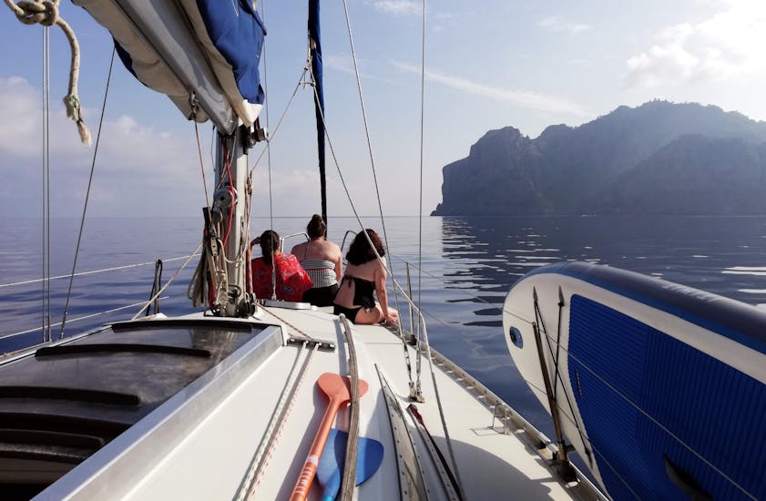 3 girls are looking at the beautiful sea from the boat during the Private Sailing Trip to Sa Calobra from Port de Sóller with Let's Sail Mallorca.