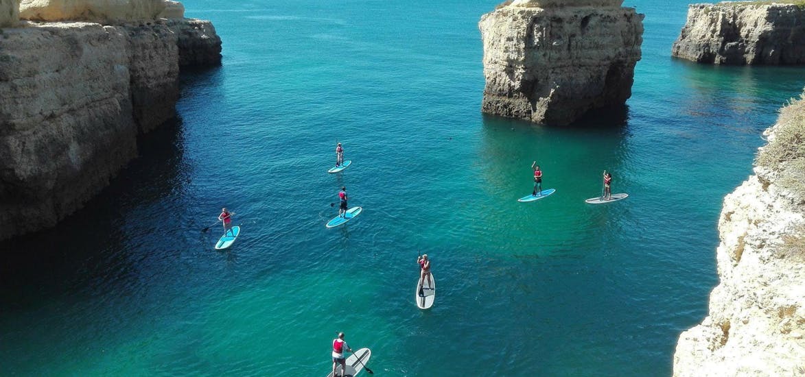 People doing the SUP Tour from Praia do Castelo to the Caves and Cliffs with Albufeira Surf & SUP.