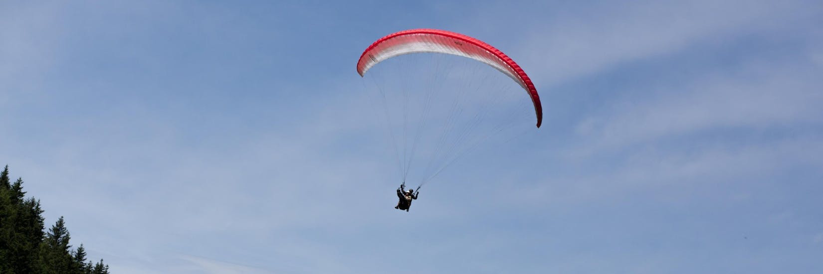 A tandem paraglider in the air during Tandem Paragliding from Bischling - Summit Flight with Flugschule Austriafly Werfenweng.