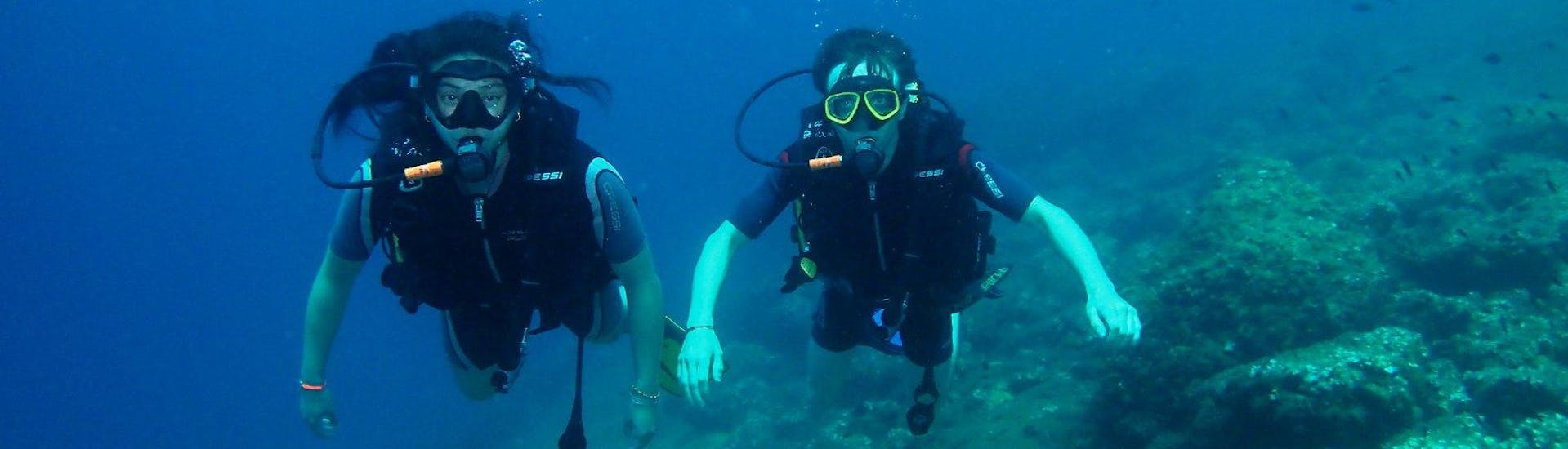 Two divers exploring the sea bed in Benidorm.