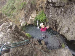 A girl is doing the Canyoning Tour - Rio de Frades with Detours Porto.