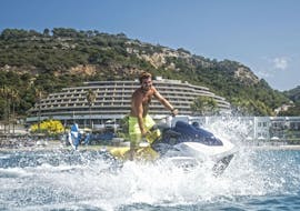 A man is riding a jet ski in Ixia with Windsurfers World Rhodes.