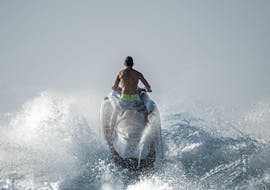 A man rides a jetski at Ixia beach with Windsurfers World Rhodes.