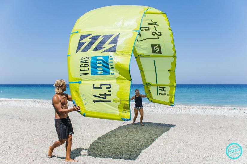 Man holding a kite during the kitesurfing lessons for beginners Air Riders Kite Pro Center Rhodes.