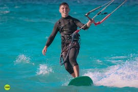 Man surfing during the kitesurfing lessons for beginners Air Riders Kite Pro Center Rhodes.