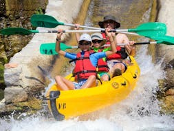 Un père et ses deux enfants descendent la rivière Ardèche et s'amusent lors de leur Location de canoë en Ardèche - Maxi-descente 12km avec ALB Canoës.