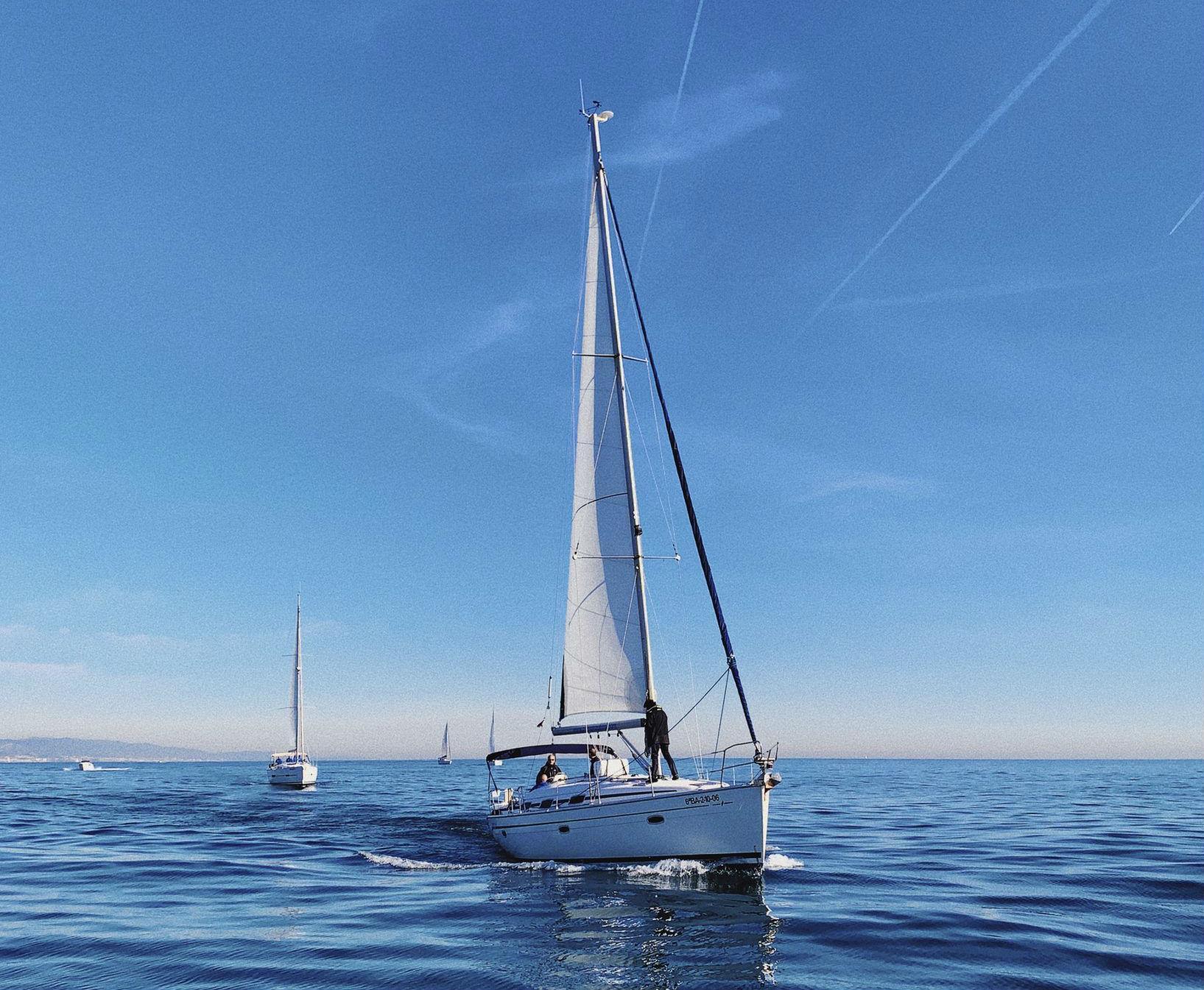 During the Private Sailing Tour with Swimming (up to 11pax) - Barcelona, a group of friends is sailing with their private skipper from Five Star Barcelona.