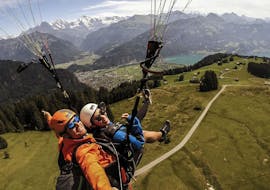 A tandem pilot from Skywings Interlaken and his passenger are seemingly enjoying themselves during the activity Tandem Paragliding in Interlaken - "The Sensational".