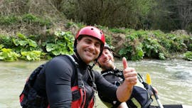 View of two people smiling in a raft boat during the Classic Rafting on the River Corno with Rafting Nomad.