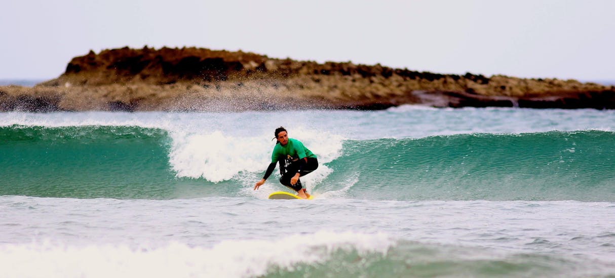 A small wave for a surfer during a Surfing Lessons for Kids and Adults - Advanced with Amado Surf School.