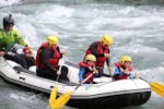 A family is taking part into the Rafting on the Doron de Bozel for Families with Evolution 2 Peisey Vallandry - H2o Sport.