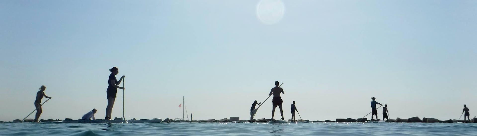 Participants paddle boarding in Barcelona during lessons provided Moloka´i SUP Centerby 