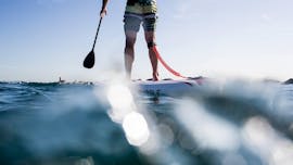 A participant paddle boarding in Barcelona with rental provided Moloka´i SUP Centerby 