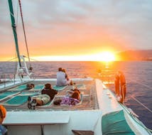 People admiring the beauty of the sunset during the Sunset Catamaran Trip with Dolphin and Whale Watching with VMT Madeira.