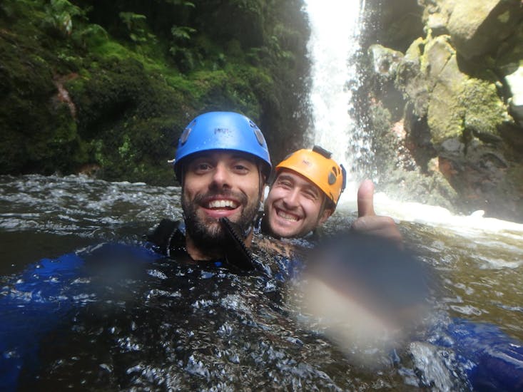Two guys are taking a selfie in the waters of the island during the Canyoning in Ribeira dos Caldeirões - Half Day.