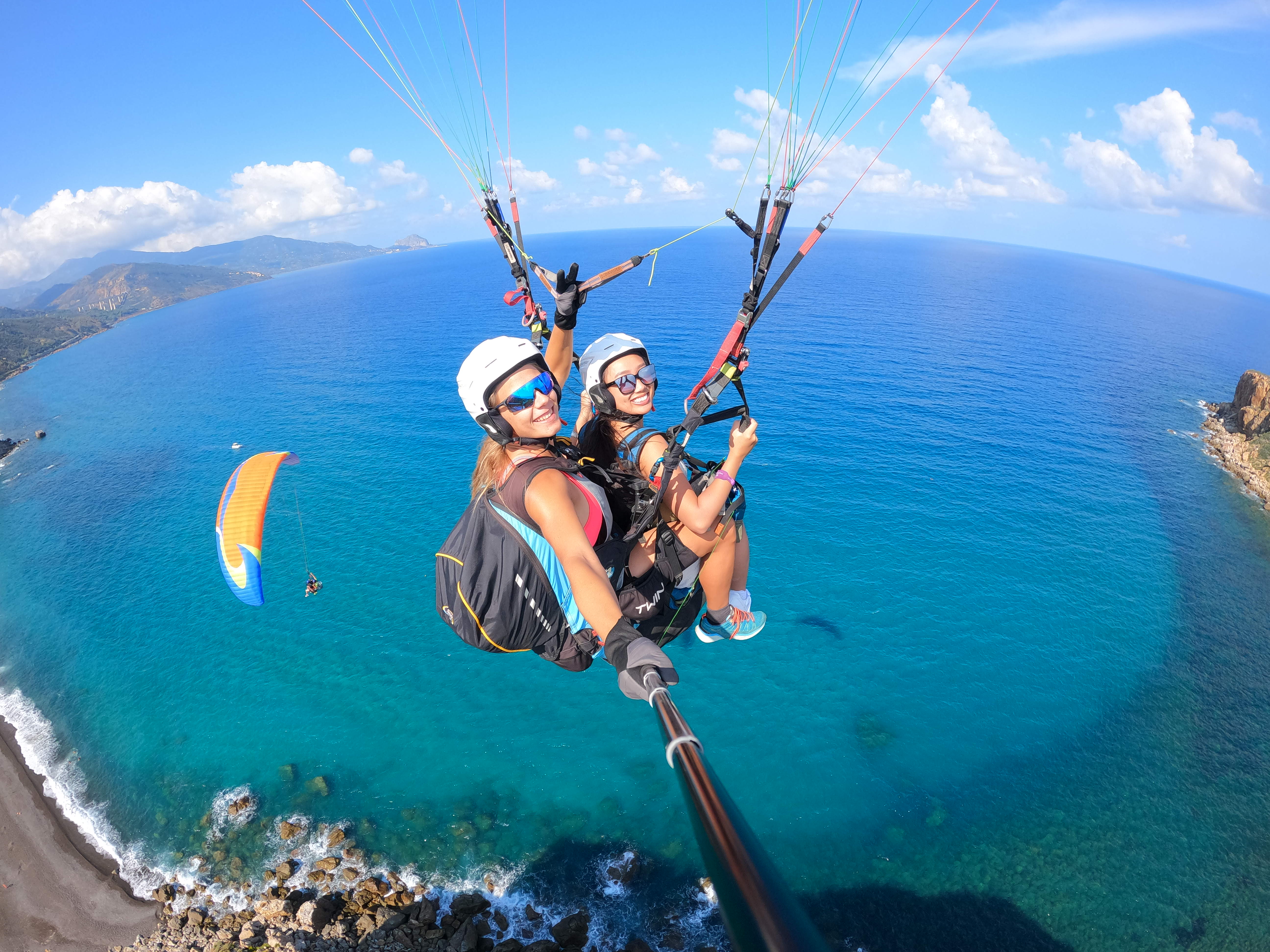 Two people are having fun during the Tandem Paragliding in Pollina - Classic with Sicily Paragliding.
