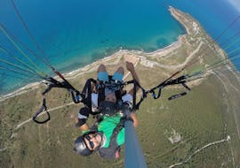 Our pilot is taking a nice picture during the Tandem Paragliding from Trapani with Sicily Paragliding.