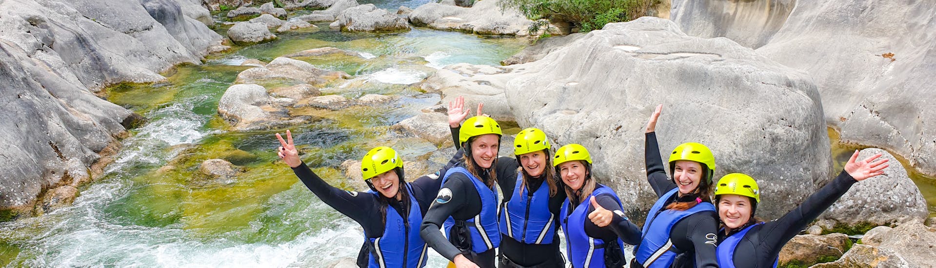A group of people from Iris Adventure Dalmatia on a rock by the Cetina River.