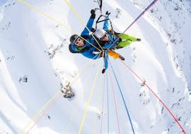A woman during her Tandem Paragliding from Nebelhorn in Winter.