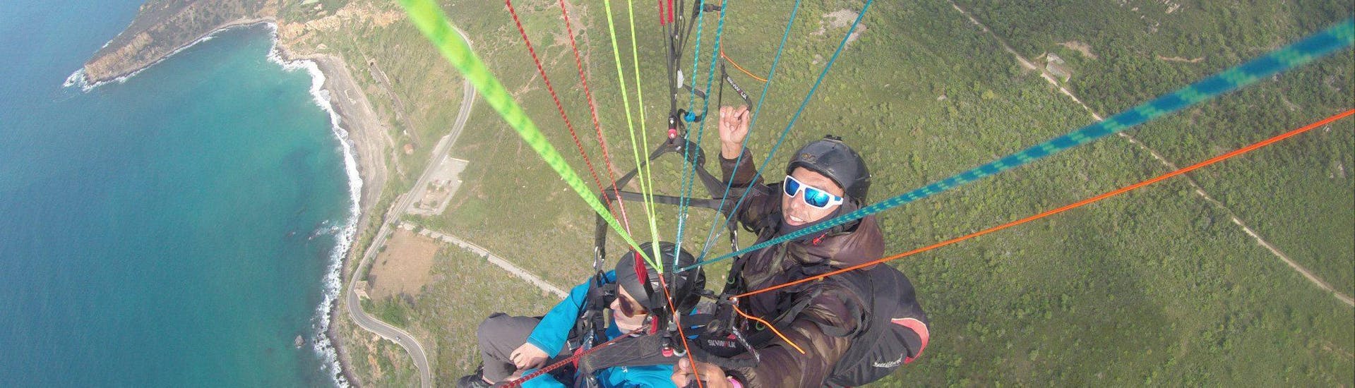 Two people smiling at the camera during the Tandem Paragliding from Taormina to Letojanni Beach.