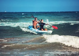 A couple is paddling around the Mediterranean Sea with their kayak rental in Cullera from Anywhere Watersports.