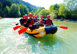 A group of people in a rafting boat while Rafting on the Enns River in Schladming with myadventure Schladming.