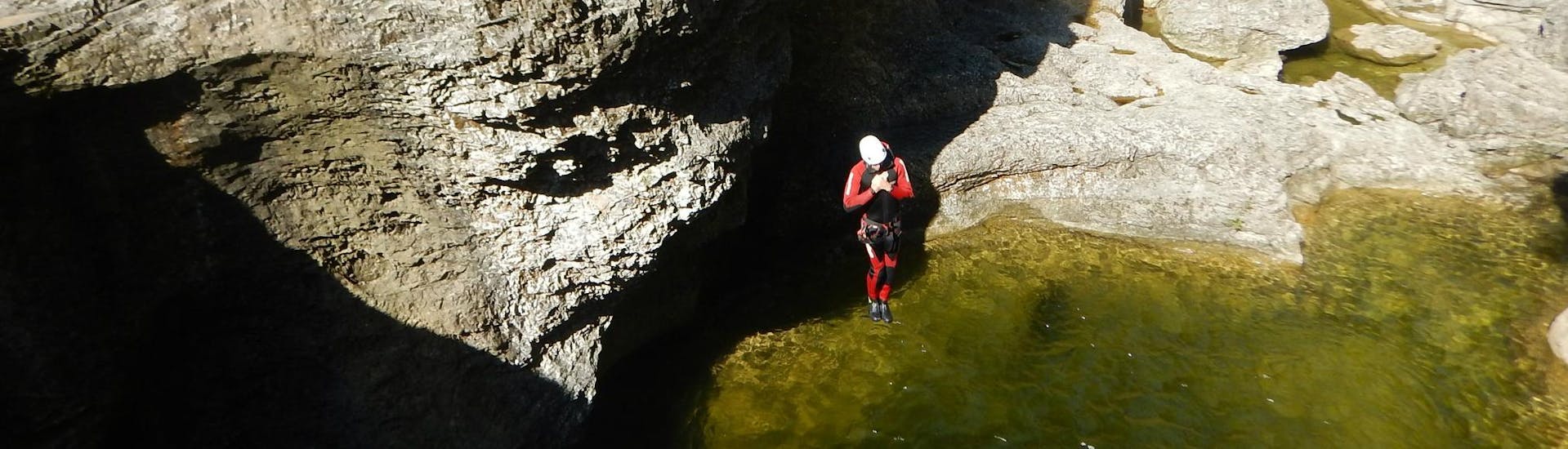 A person jumping into the water during Canyoning near Hallein for Adventurers - Jump'n Fun Special with myadventure Schladming.