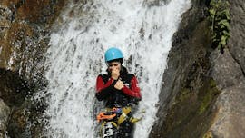 A canyoning enthusiast is going down a slide during Canyoning "Discovery" - Canyon de la Haute Besorgues with Les Intraterrestres.