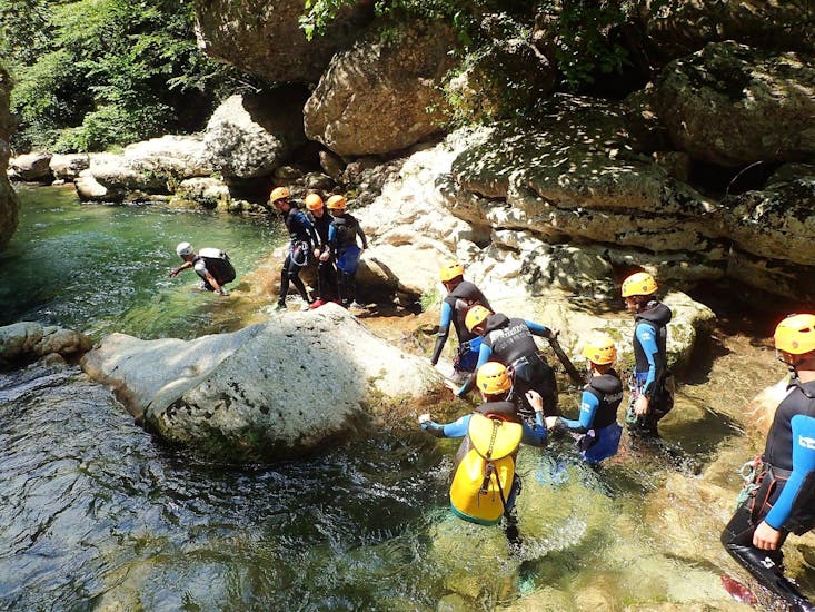 A group of children is advancing in the riverbed during their Canyoning in Gorges du Loup - Level 2 tour with FunTrip.